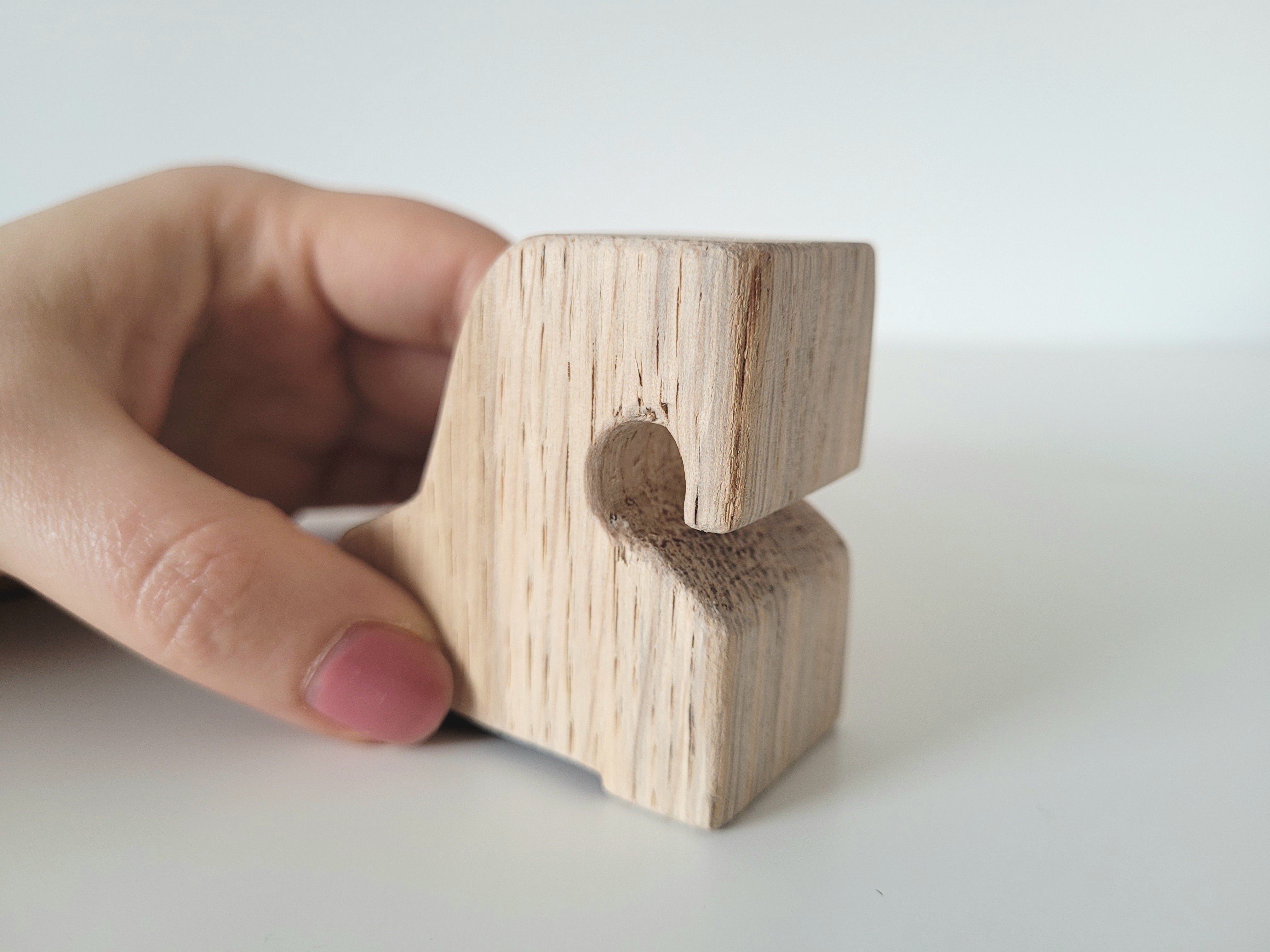 Größenvergleich Holtpferdchen Eine Hand hält ein Holzpferdchen.